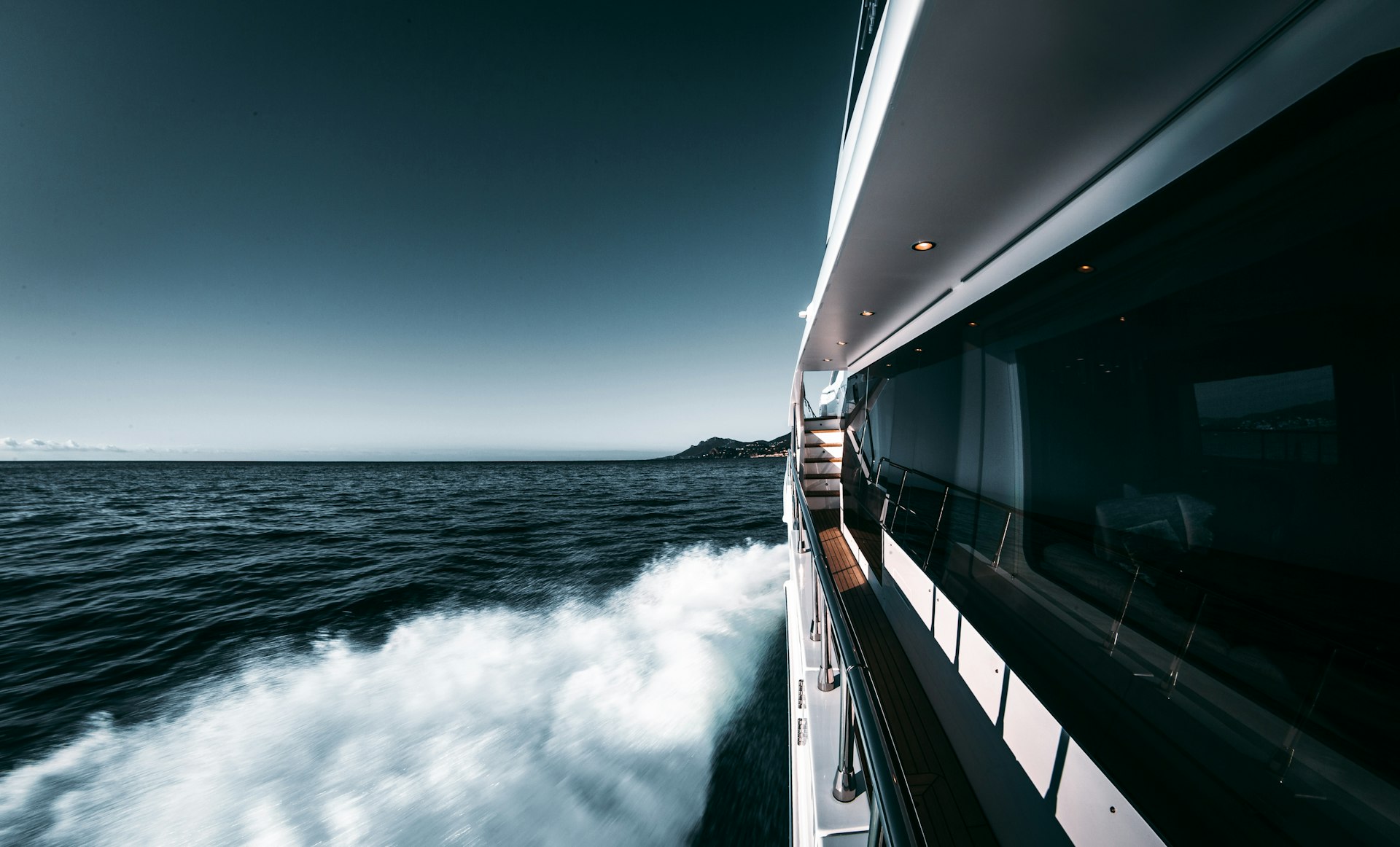 Luxury motor yacht cruising on calm blue water off the Florida coast